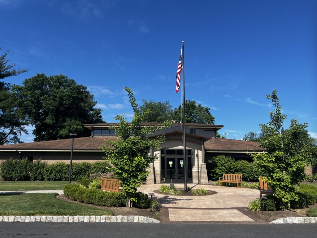 The exterior of Fairfield Public Library, with an American flag in a courtyard out front.